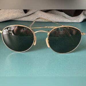 Used good condition authentic RayBans. Round black and gold sunglasses.